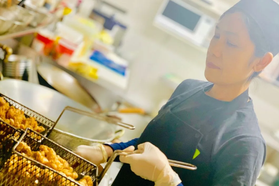 Chai-Yo chef frying fresh food in the café kitchen