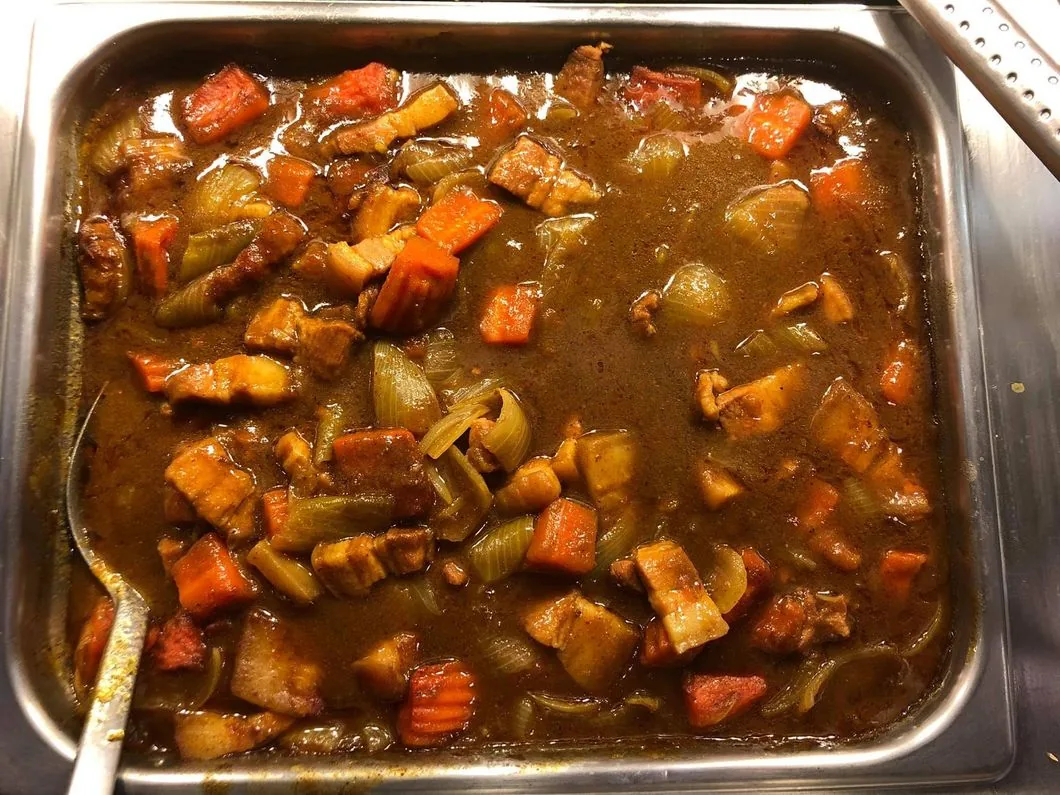 Tray of hot curry with carrots and green beans ready to serve