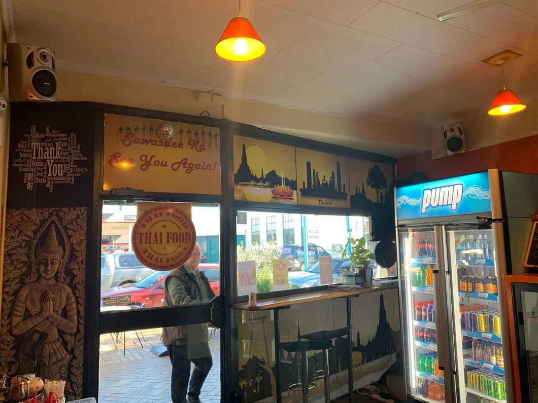 Customer standing by the window inside Chai-Yo Café