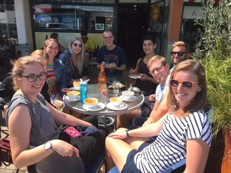 Group of customers sitting around a table eating at Chai-Yo Café